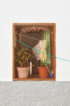 An old window of an old old kitchen in a house in a small town in Spain. Stock Photos