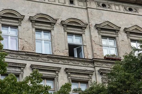 An old window is open and the trees are green Foto stock