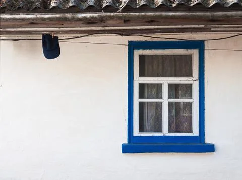 Old window outside a rustic white house Stock Photos