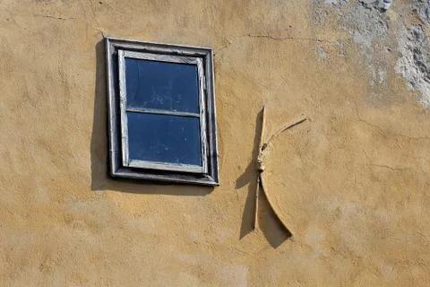 Old window on the shabby wall Stock Photos