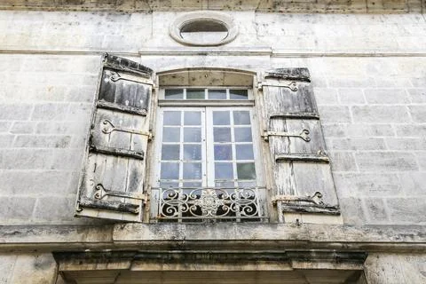 A old window with shutters is open in Cognac France, letting in some light Stock Photos