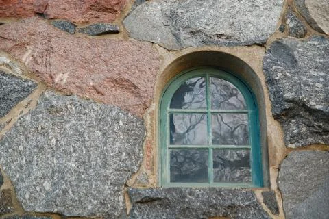 Old window in wall made of big stones Stock Photos