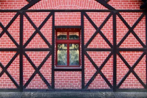 Old window in wall of red brick and wood frame Stock Photos