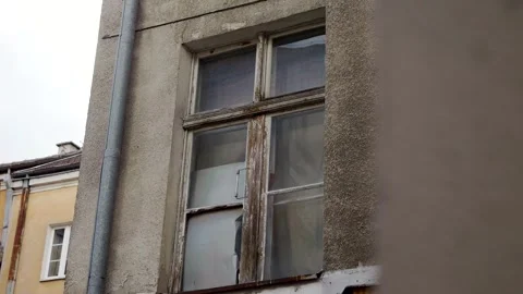 Old Window on a Weathered City Building Stock Footage 345695371