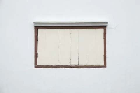 Old window on a white wall. Stock Photos
