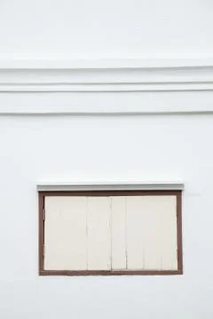 Old window on a white wall. Stock Photos