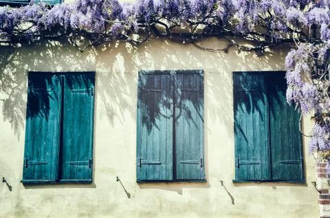 Old windows with blue shutters. Stock Photos