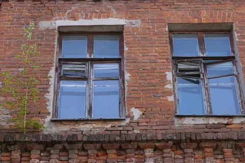 Old windows in a brick house with a reflection of the sky. Architectural ba.. Stock Photos
