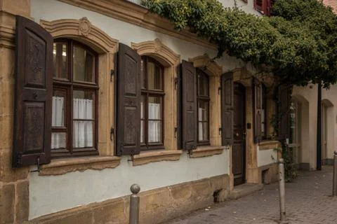 Old windows made of stone and wood with brown shutters Фото