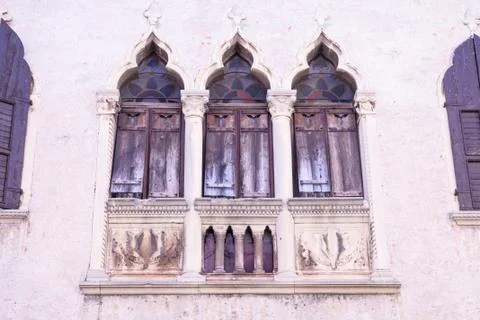 Old windows on a medieval palace facade in Verona Stock Photos