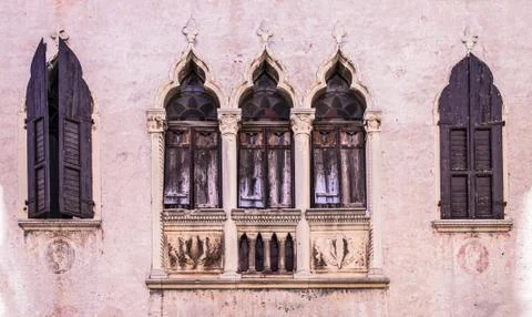 Old windows on a medieval palace facade in Verona Stock Photos