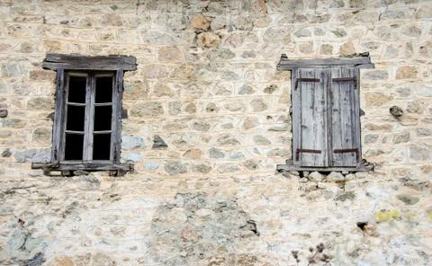 Old Windows one open one closed on a destroyed wall Stock Photos