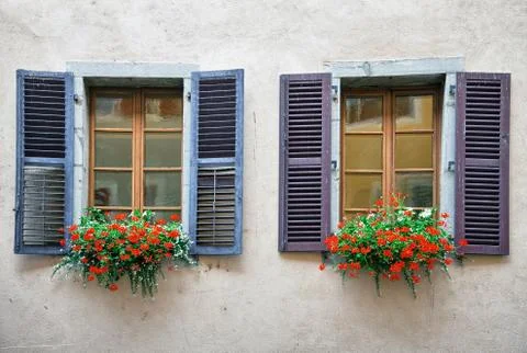Old windows on plastered brick wall Stock Photos