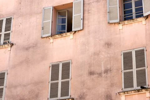 Old windows on the wall of a house Stock Photos