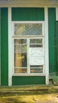 Old windows with white frames on the green wall Stock Photos