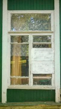 Old windows with white frames on the green wall Stock Photos