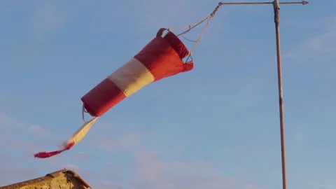 Old windsock swaying in the wind at sunset Stock Footage 260080186
