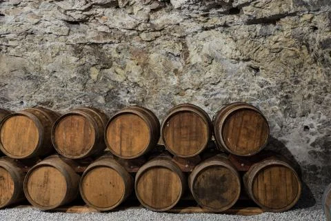 An old wine cellar with oak barrels full of red wine Stock-Fotos