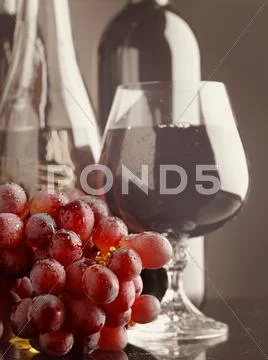 Old wine. still life with wine bottles and goblet Stock Photos