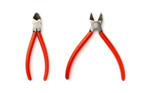 Old wire cutters with red handle isolated on white. Stock Photos