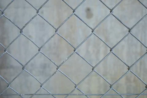 An old wire mesh with a diamond pattern. Stock Photos