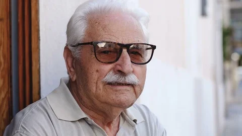 Old wise man looks at the camera, close up portrait Stock Footage 81170539