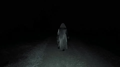 Old witch walking down dark spooky road.  Stock Footage 145030321