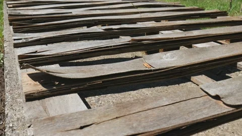 Old withered boards lie one after another in the sun. Plywood cracked over time Stock Footage 167947643