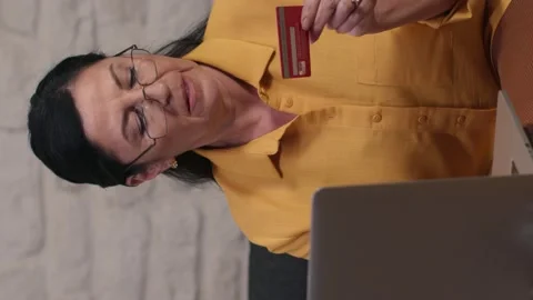 Old woman buys something on computer using credit card, e-commerce internet. Stock Footage 146452652