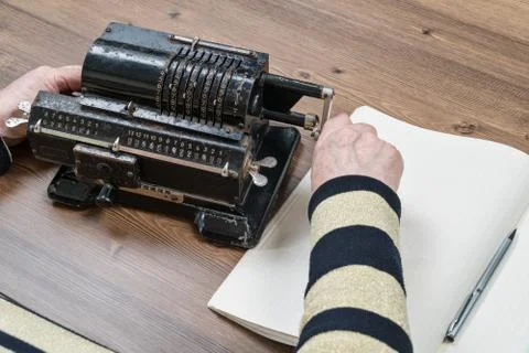 Old woman counts on an adding machine Stock Photos