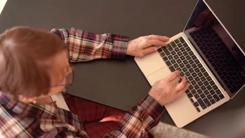 Old woman eighty years old sitting with laptop Stock Footage 253184044