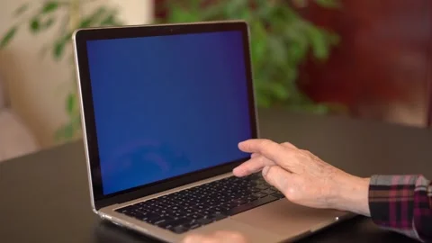 Old woman eighty years old sitting with laptop Stock Footage 253184089