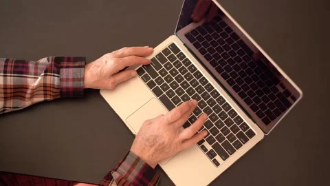 Old woman eighty years old sitting with laptop Stock Footage 253423997