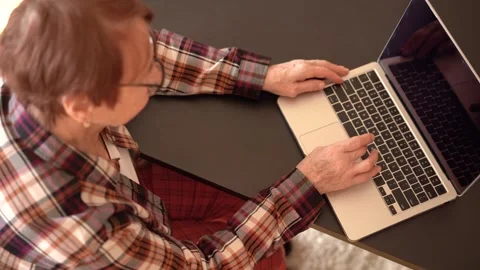 Old woman eighty years old sitting with laptop Stock Footage 253501283