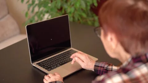 Old woman eighty years old sitting with laptop Stock Footage 253501301