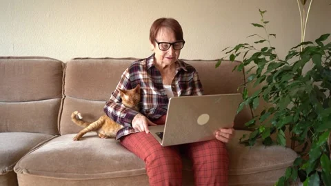 Old woman eighty years old sitting with laptop Stock Footage 253501404