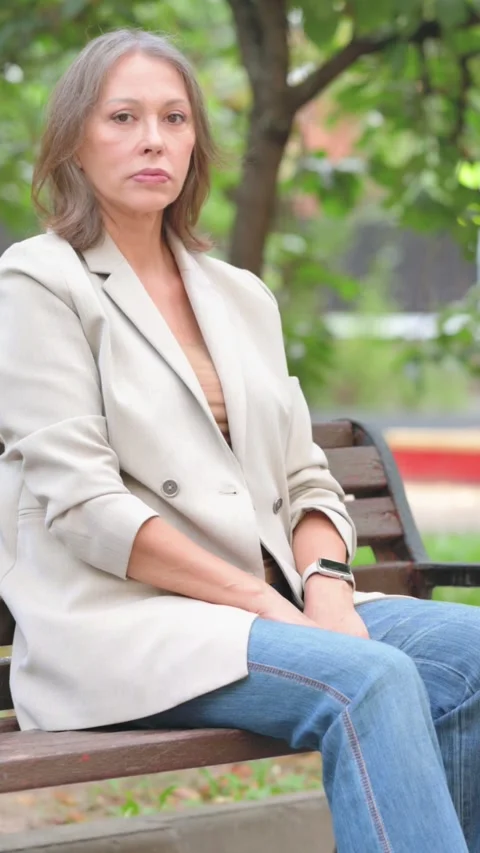 Old Woman Looking at Camera while Sitting on Bench Outdoor 動画素材 319967892