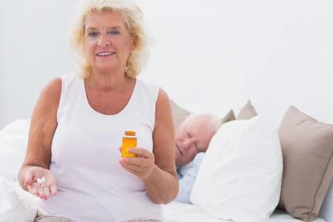 Old woman with the opened pill bottle Stock Photos