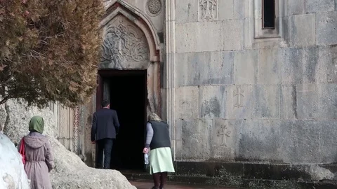 Old woman prays leaving church,distance Stock Footage