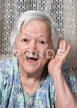 Old woman putting hand to her ear Stock Photos