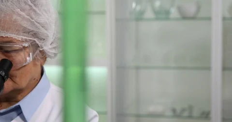 Old Woman Researcher Looking Through Microscope Laboratory Researching Diseases Stock Footage