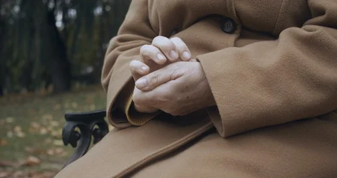 Old woman rubbing hands close-up, suffering arthritis pain, aging health problem Stock Footage