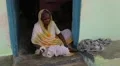 Old woman in sari taking the wheelchair in India HD Footage
