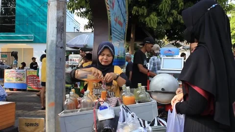 Old woman is serving a customer making an order for herbal medicine. Stock Footage 287180845