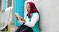 Old woman sits on bench and communicates via tablet computer HD Footage