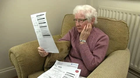 An old woman sorting through her bills Stock-Footage 20452695