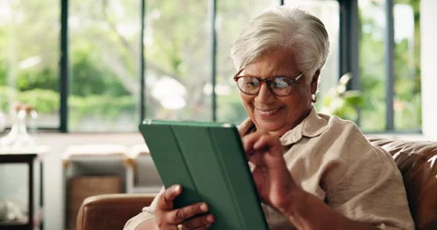 Old woman, tablet and scroll online in home with smile for communication, Stock Footage 329427917