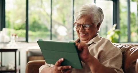 Old woman, tablet and scroll online in home with smile for communication, Stock Footage 329427967