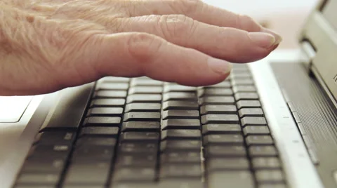 Old woman using laptop computer and typing on the keyboard Stock Footage 47831655