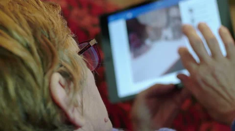 Old woman using tablet computer at home 스톡 동영상 47825331